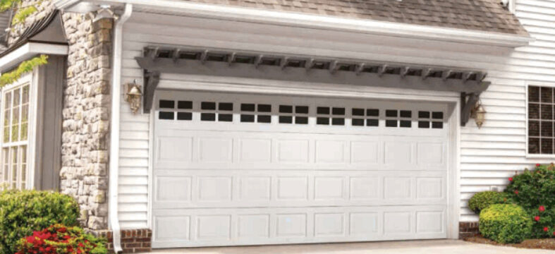 garage-door-16-feet-white-windows-torquemaster-conversion White two car garage door 16 feet long that has undergone a Torquemaster conversion to a standard spring
